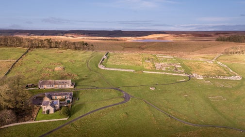 An aerial view of Housesteads, showing the close proximity to the museum, Hadrian's Wall and the Roman Fort, with Broomlee Lough in the distance, Northumberland